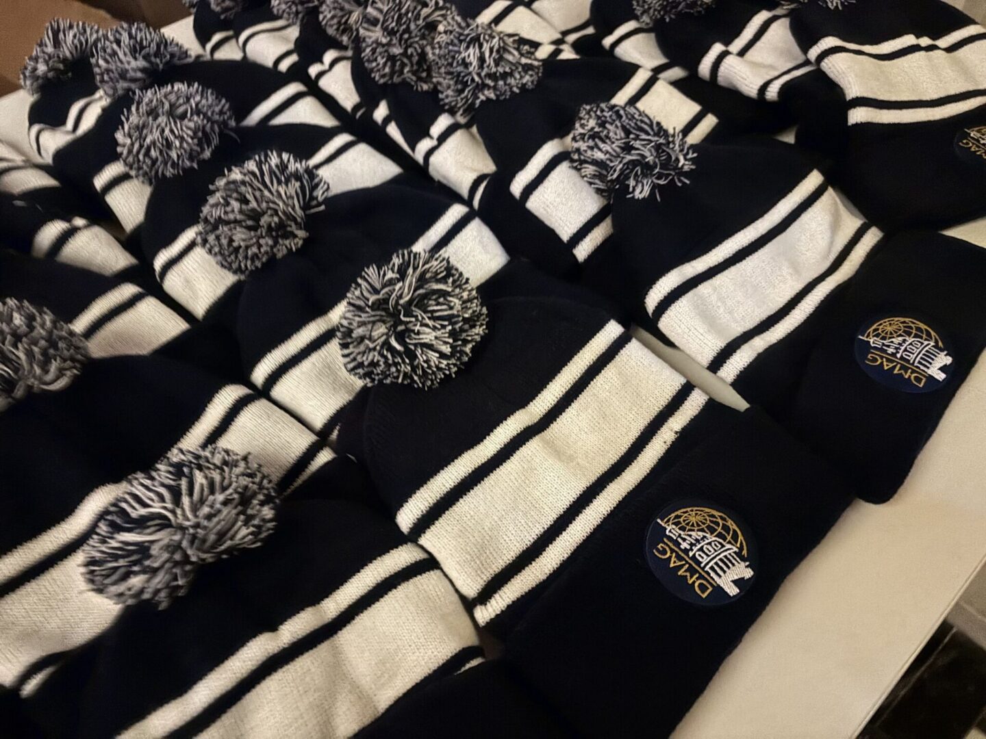 Black and white striped pom-pom beanies